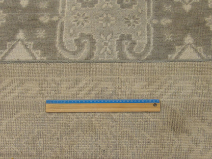 Green and beige Oushak rug in room setting