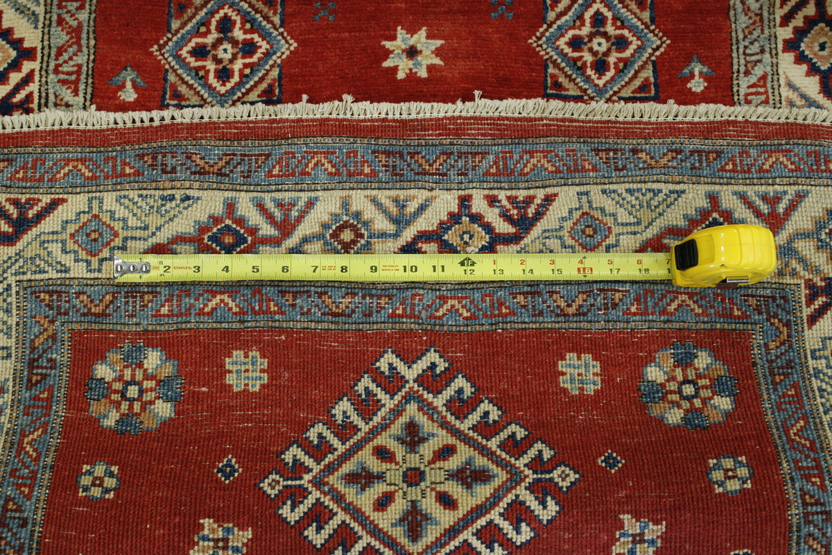 Beige & Red Tribal Super Kazak rug in room setting