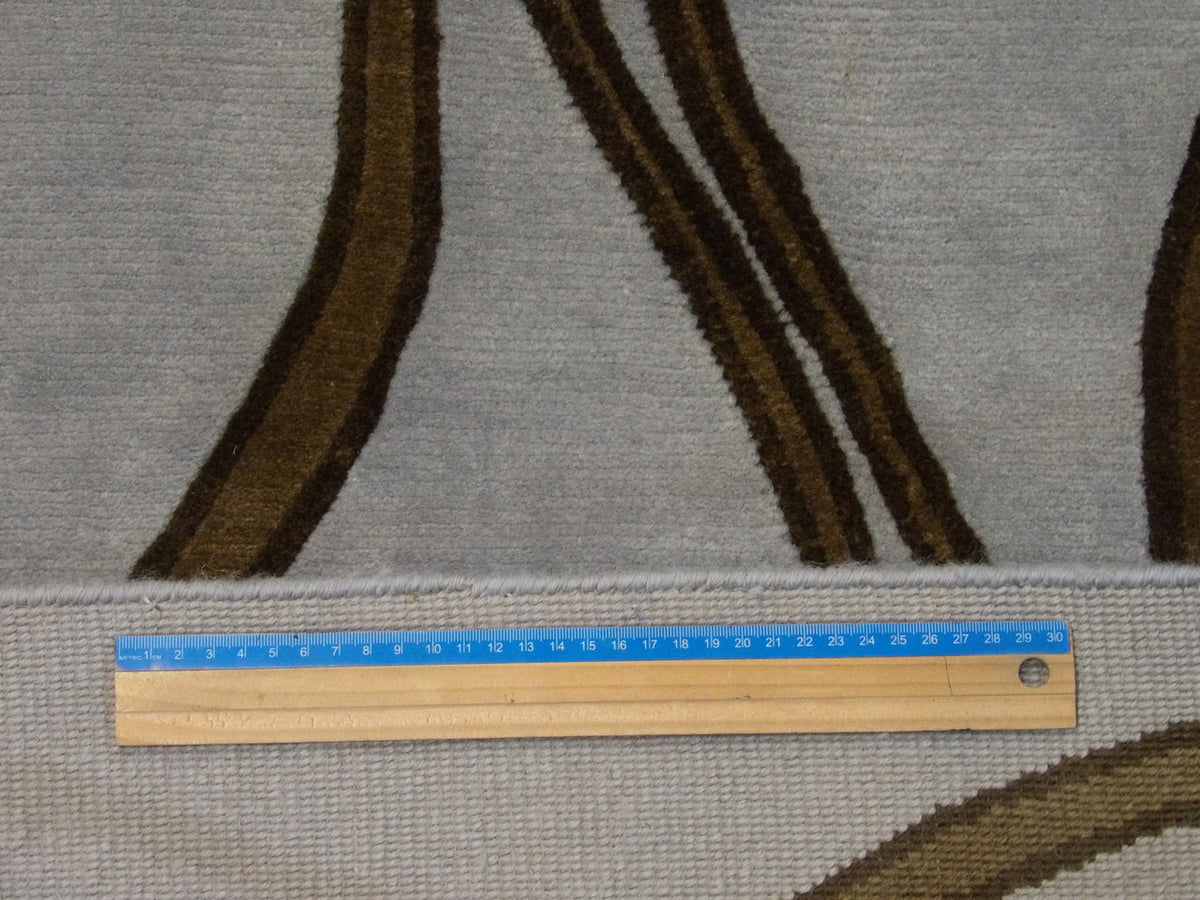 Blue and brown geometric rug in room setting