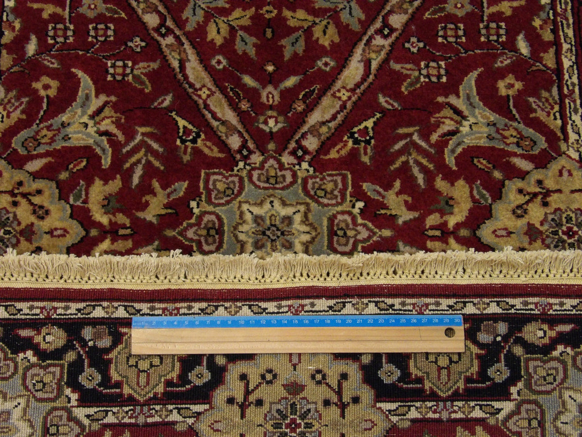 Black and red Tabriz runner in hallway setting