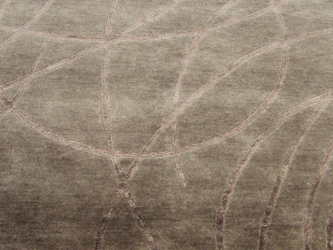 Close-up of carved wool-silk texture, gray and purple rug