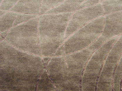 Close-up of carved wool-silk texture, gray and purple rug