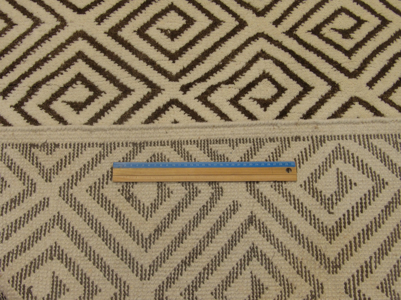 Brown and ivory Moroccan diamond rug in room setting