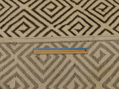 Brown and ivory Moroccan diamond rug in room setting