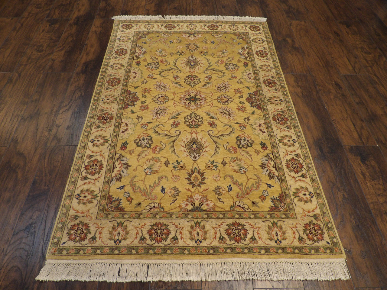 Close-up of wool pile, gold and ivory rug