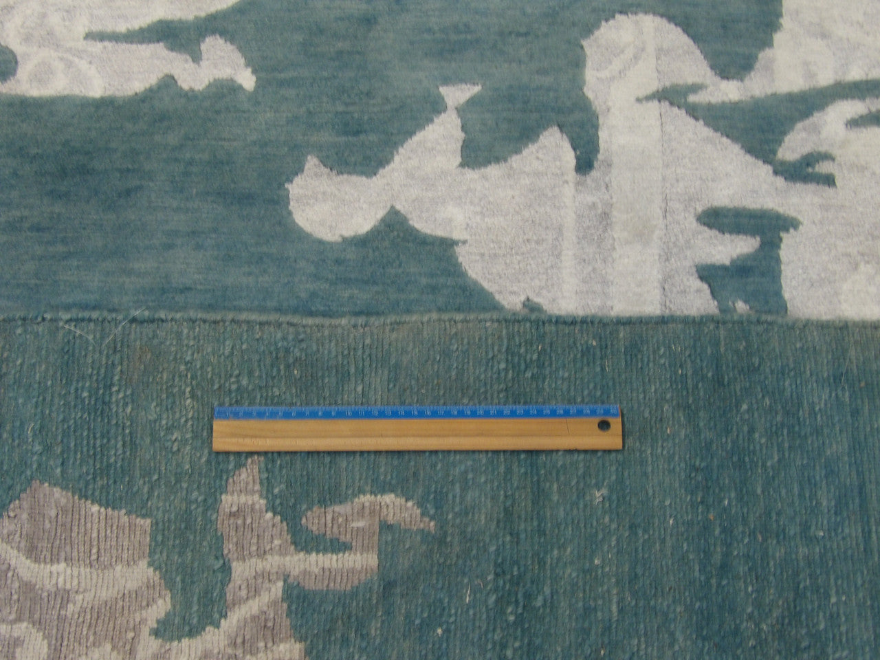 Gray and teal abstract rug in room setting