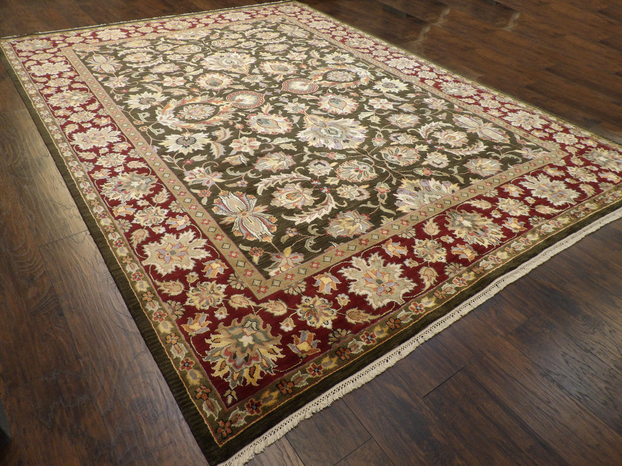 Green and red Kashan rug in a formal living room setting