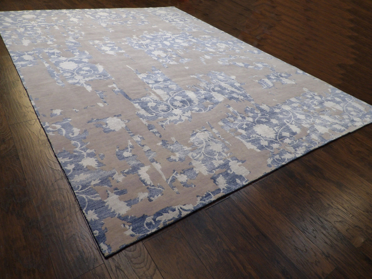 Oversized blue and white abstract rug in a great room setting