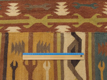 Gold and green coastal rug in room setting
