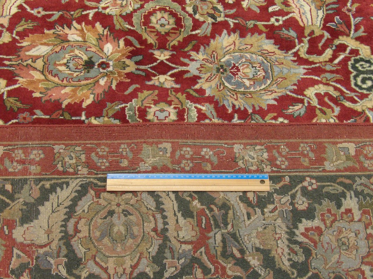 Green and red Kashan rug in room setting