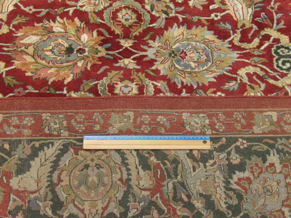 Green and red Kashan rug in room setting
