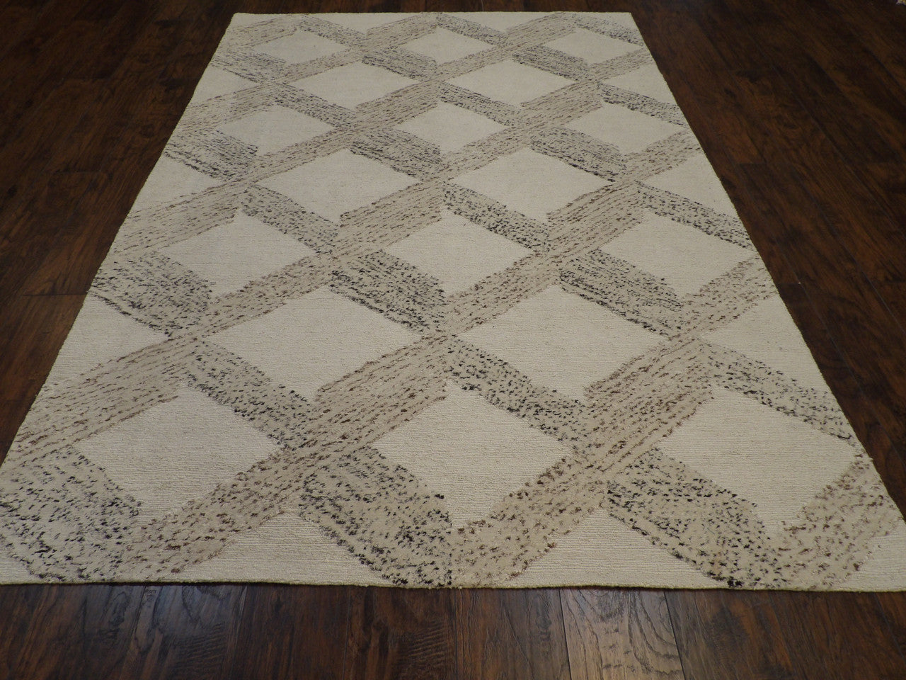 Close-up of looped wool texture, beige and brown rug