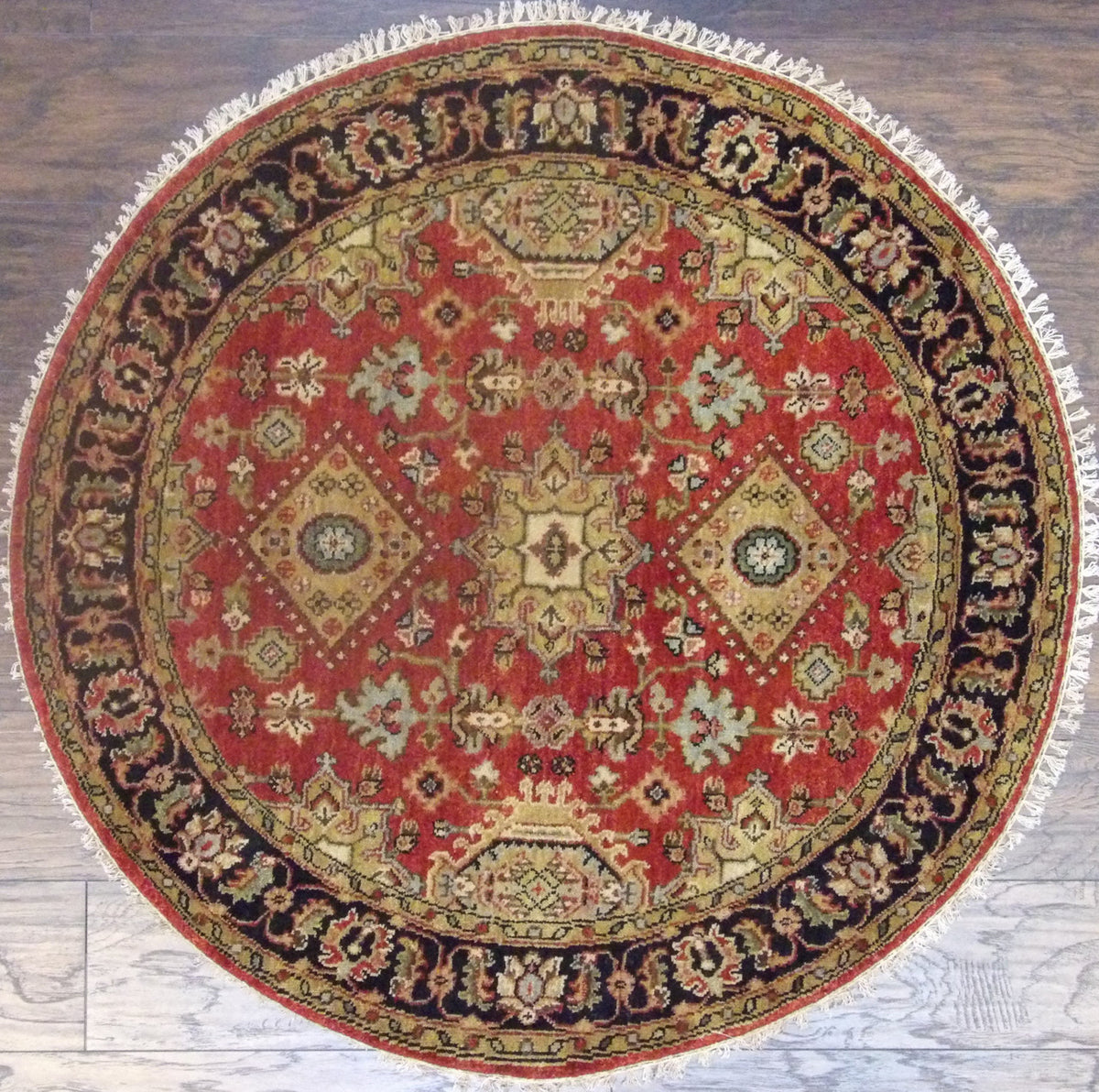 Tribal fine Serapi hand-knotted wool round rug in black and rust, full view