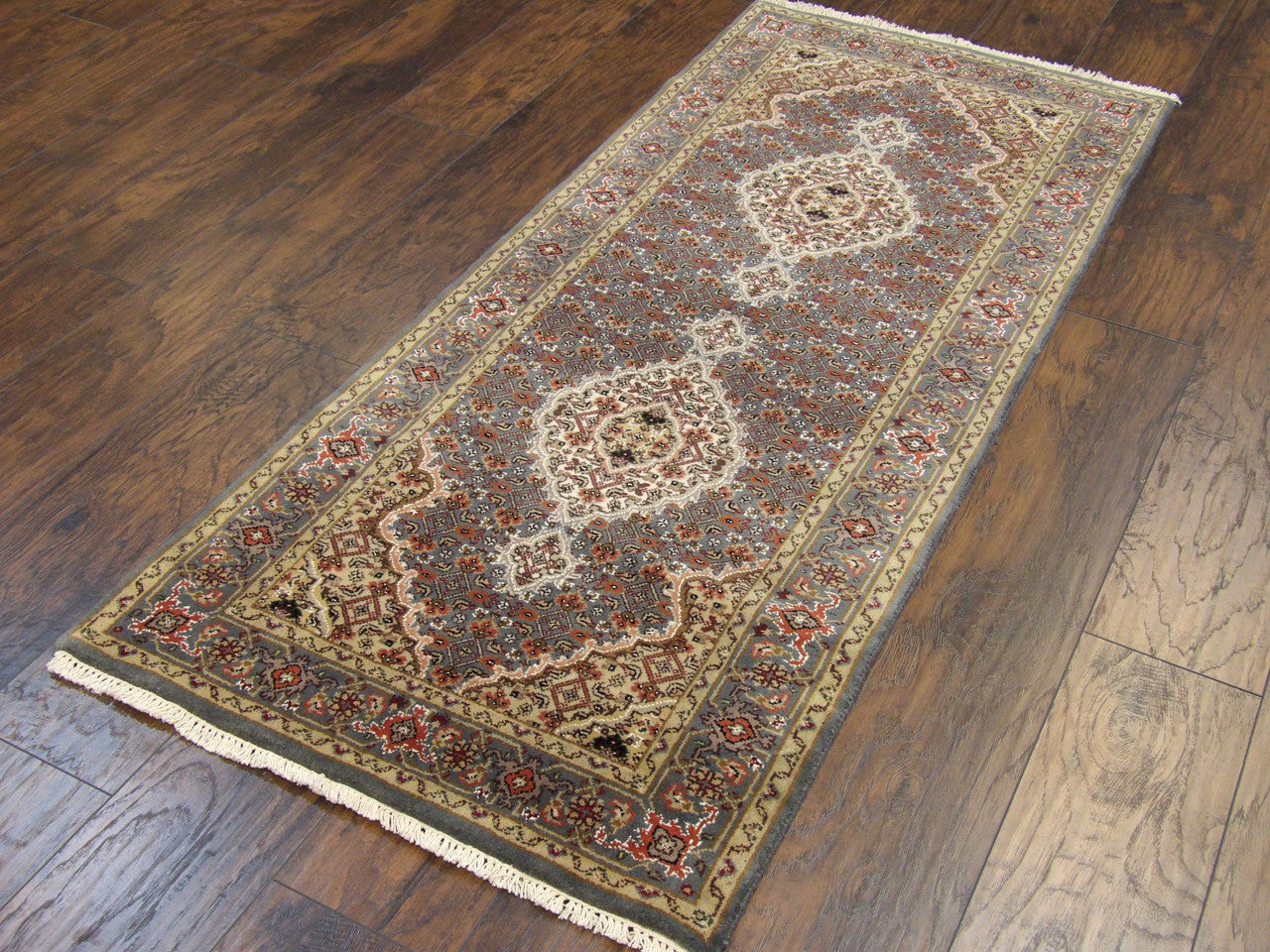 Close-up of Tabriz knot density, teal wool runner