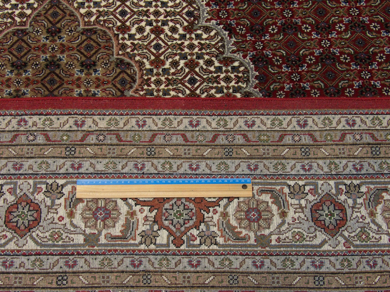 Beige & Red Fine Persian Mahi Tabriz rug in room setting