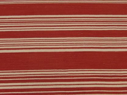 Coastal rug edge detail, beige and red flatweave