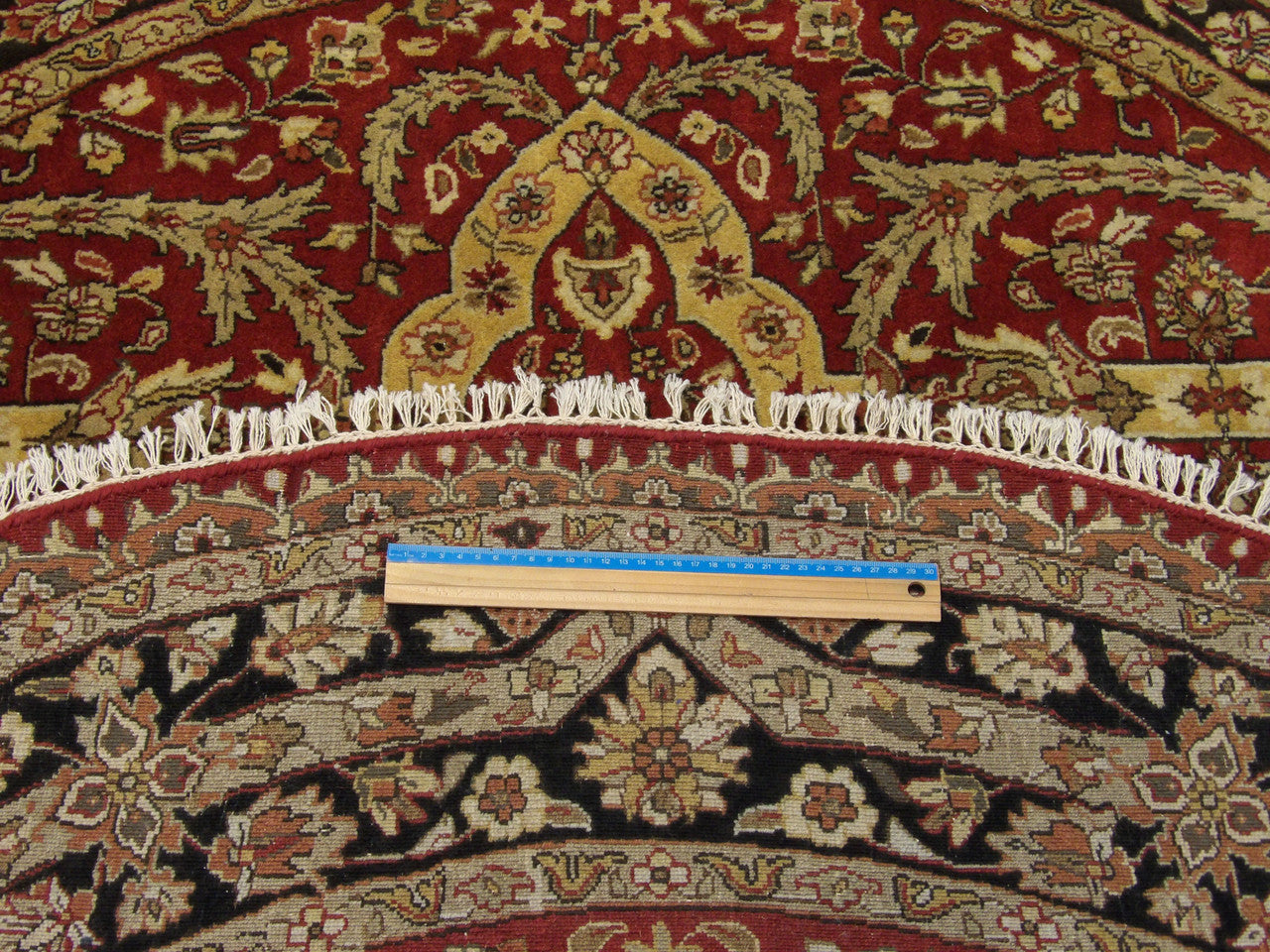 Full room view of round Persian Tabriz hand-knotted rug
