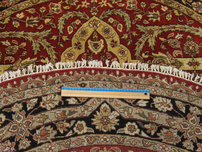 Full room view of round Persian Tabriz hand-knotted rug