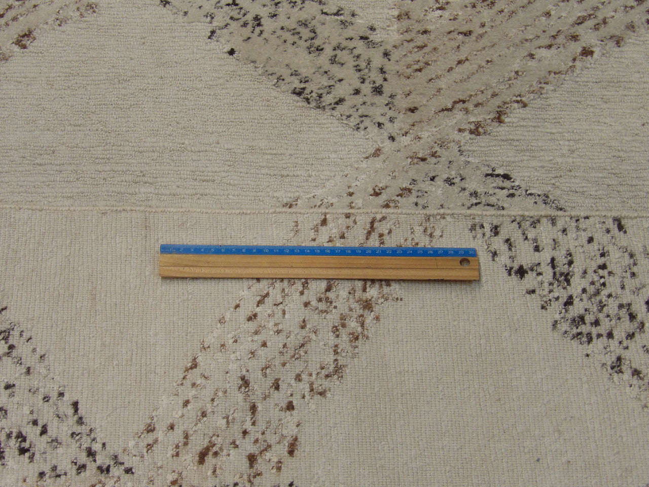 Beige and brown looped rug in room setting