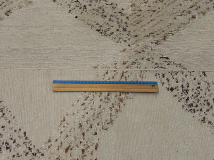 Beige and brown looped rug in room setting
