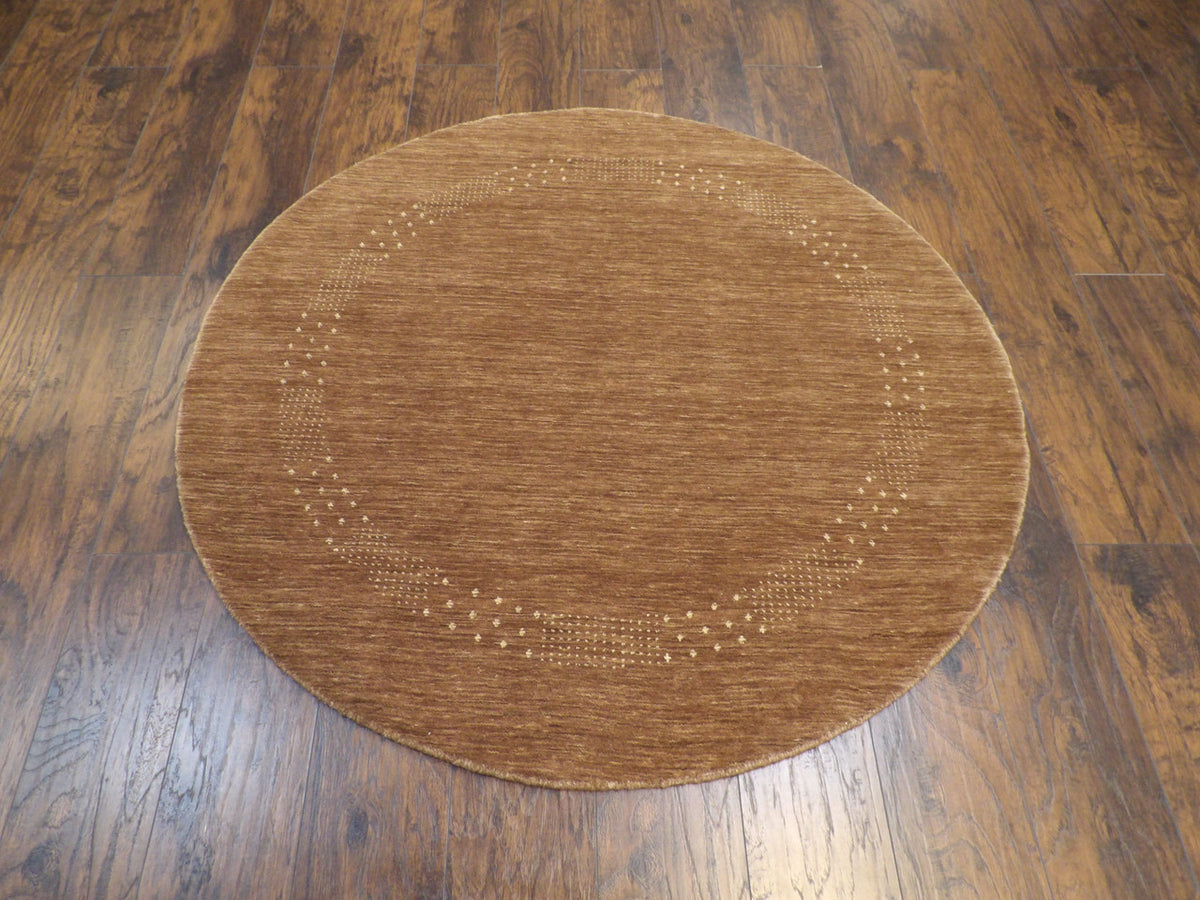 Close-up of wool pile, brown and beige round rug