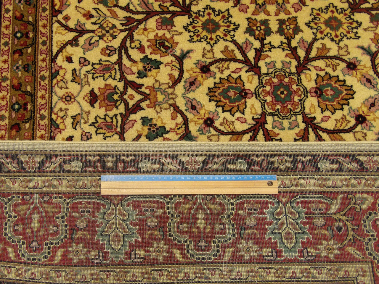 Beige & Red Fine Persian Haji Jalili rug in room setting