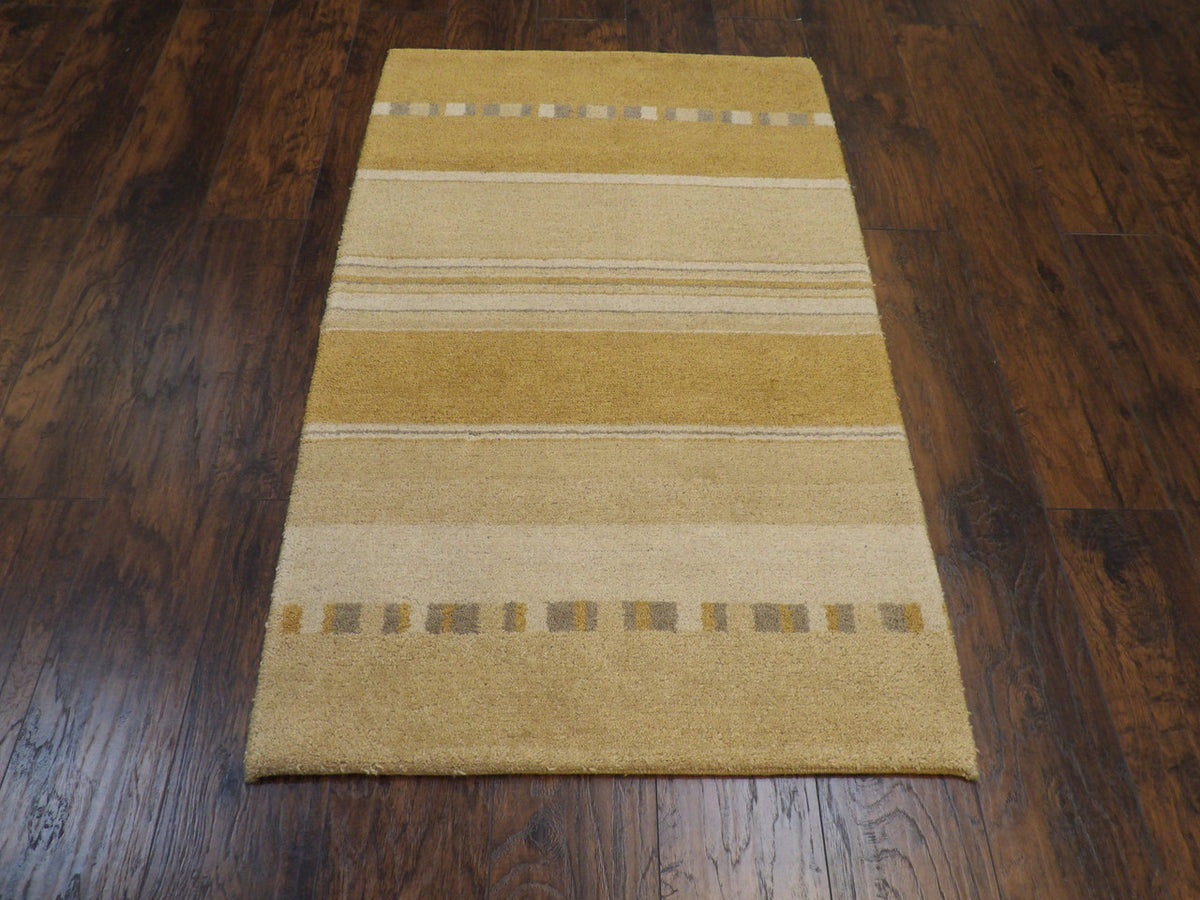 Close-up of wool pile, gold modern rug