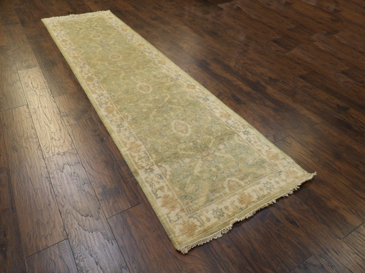 Beige Oushak runner in a hallway setting
