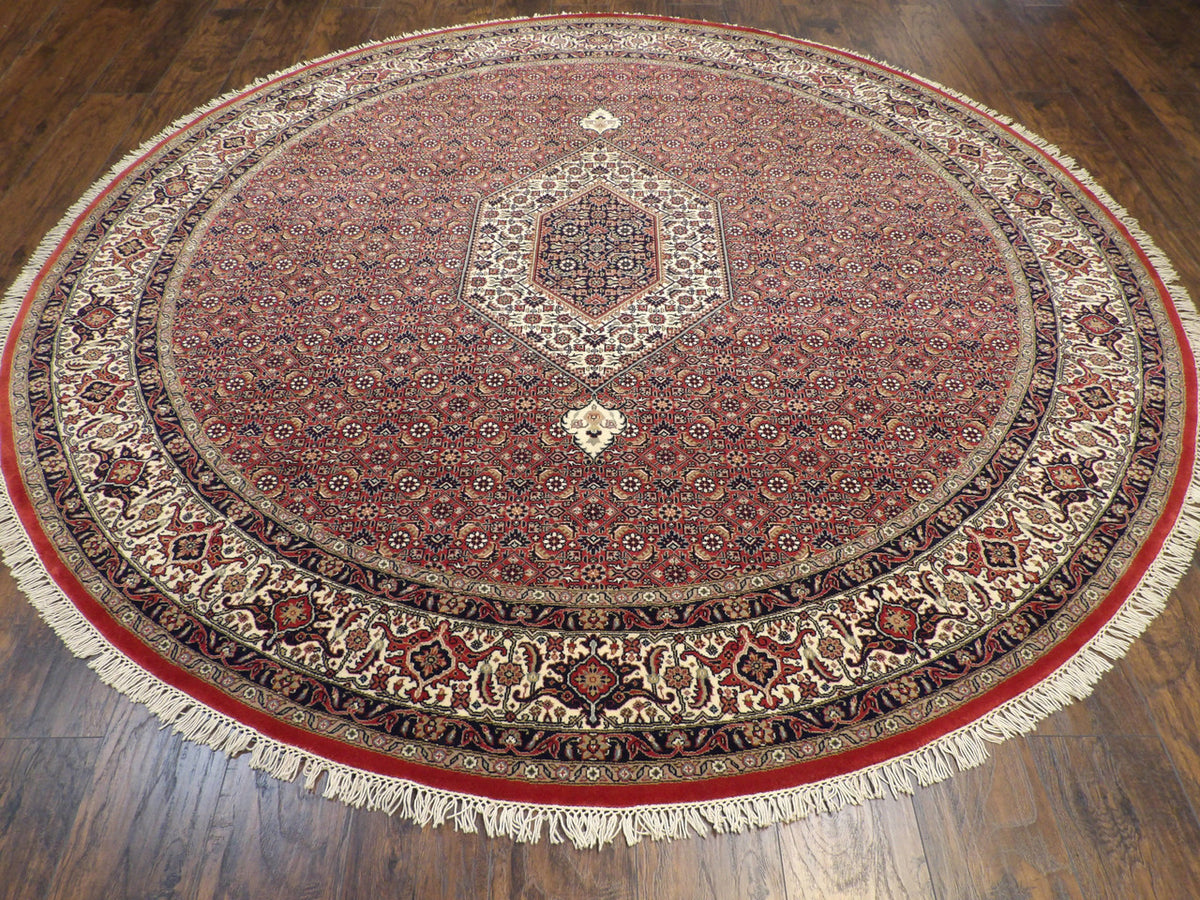 Close-up of wool pile, beige and red round rug