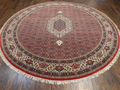 Close-up of wool pile, beige and red round rug