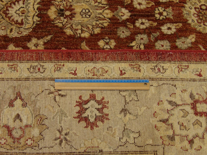 Gold and rust Oushak rug in room setting
