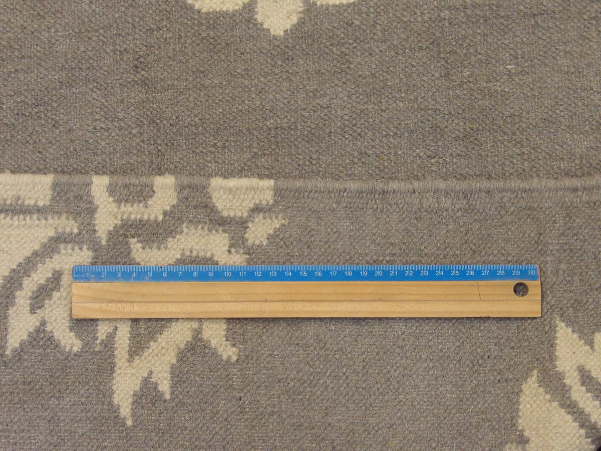 Gray and beige kilim rug in room setting