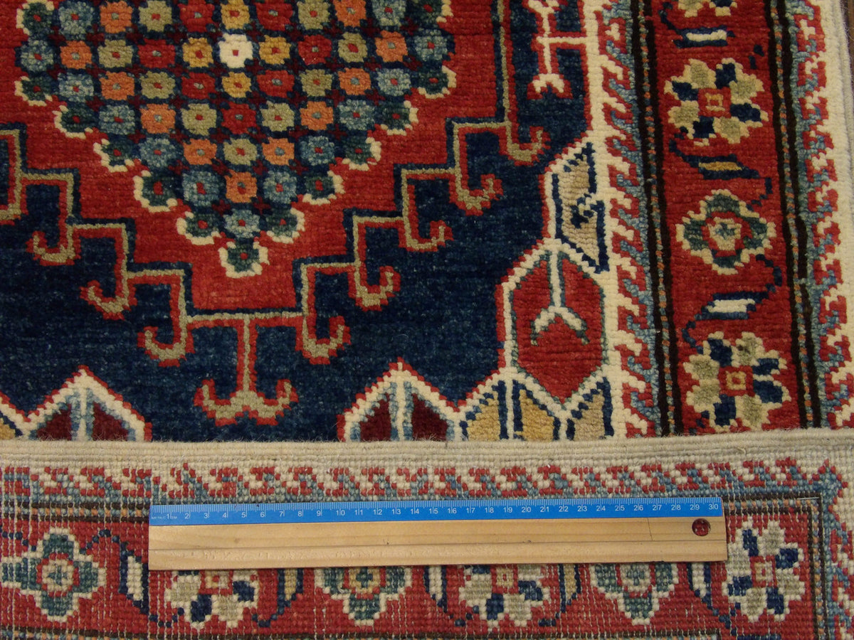 Ivory and red Kazak runner in hallway setting