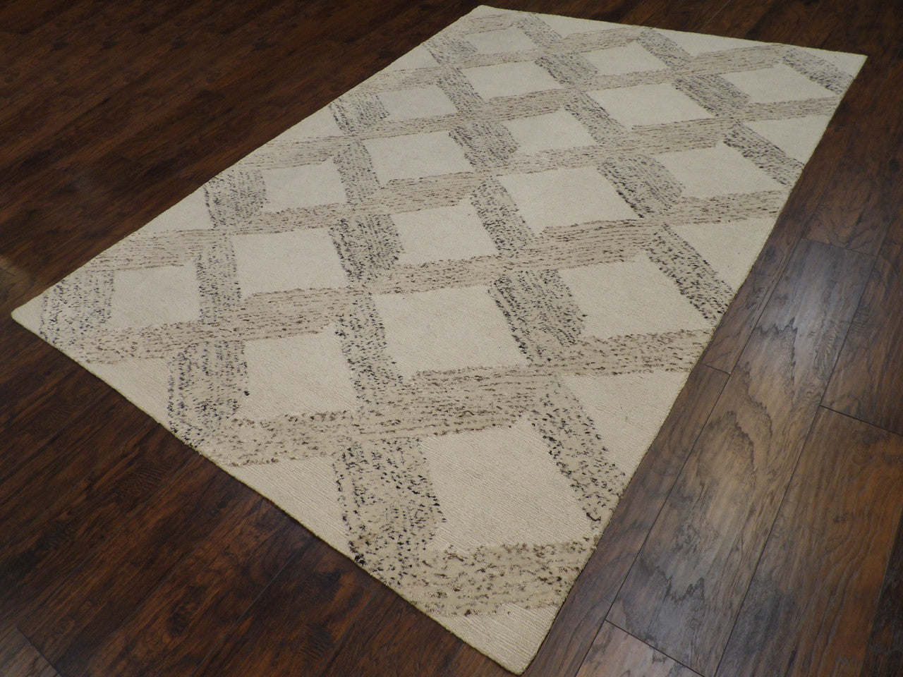 High-low loop pattern detail, beige rug