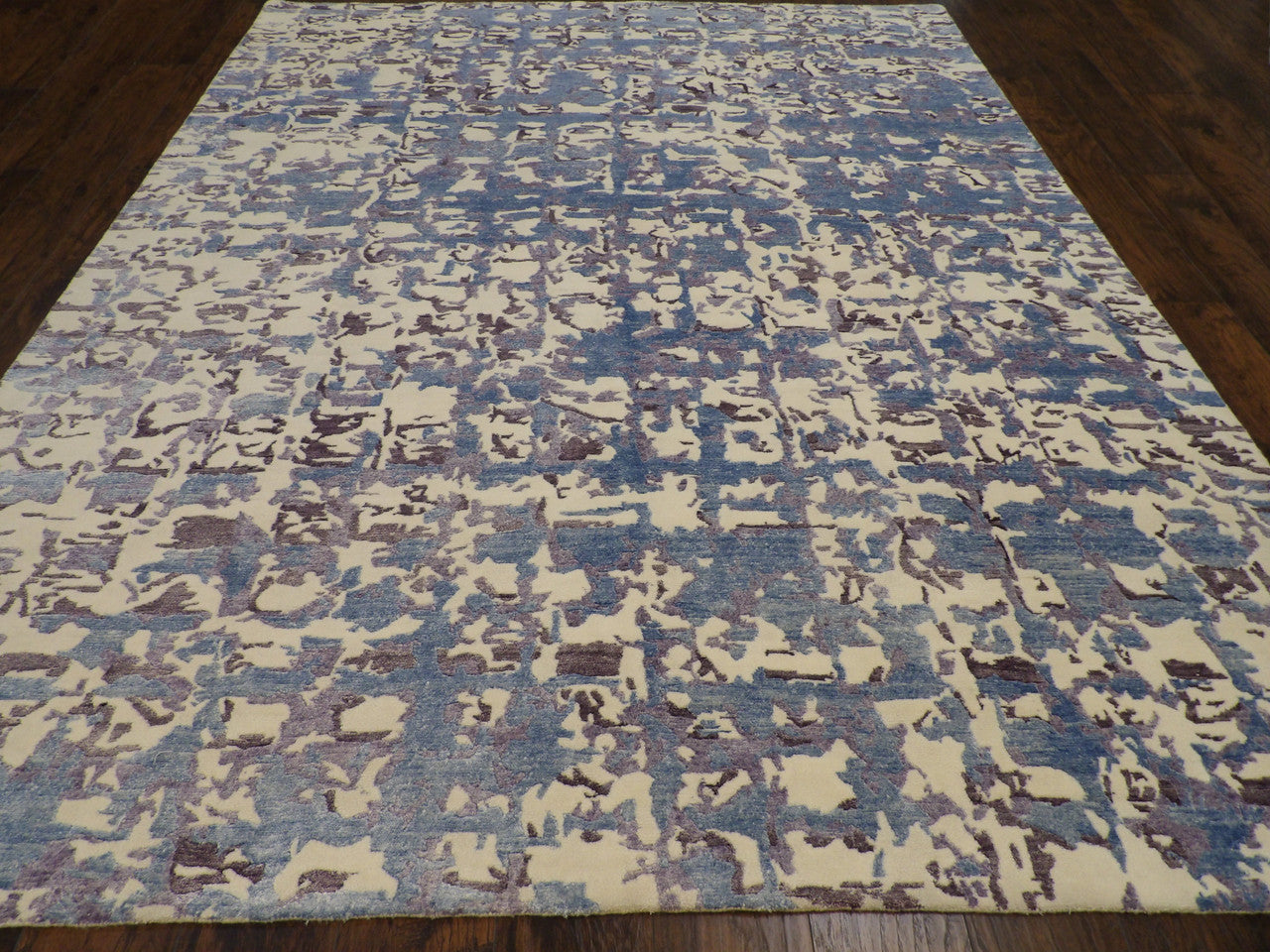 Carved abstract pattern detail, blue and white rug