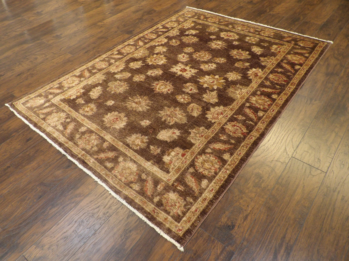 Brown and gold Oushak Chobie rug in a living room setting
