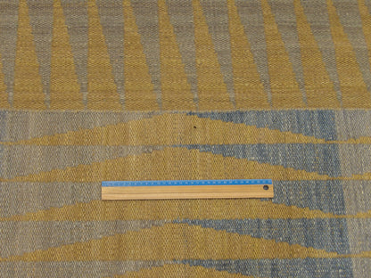 Blue and gold coastal rug in room setting