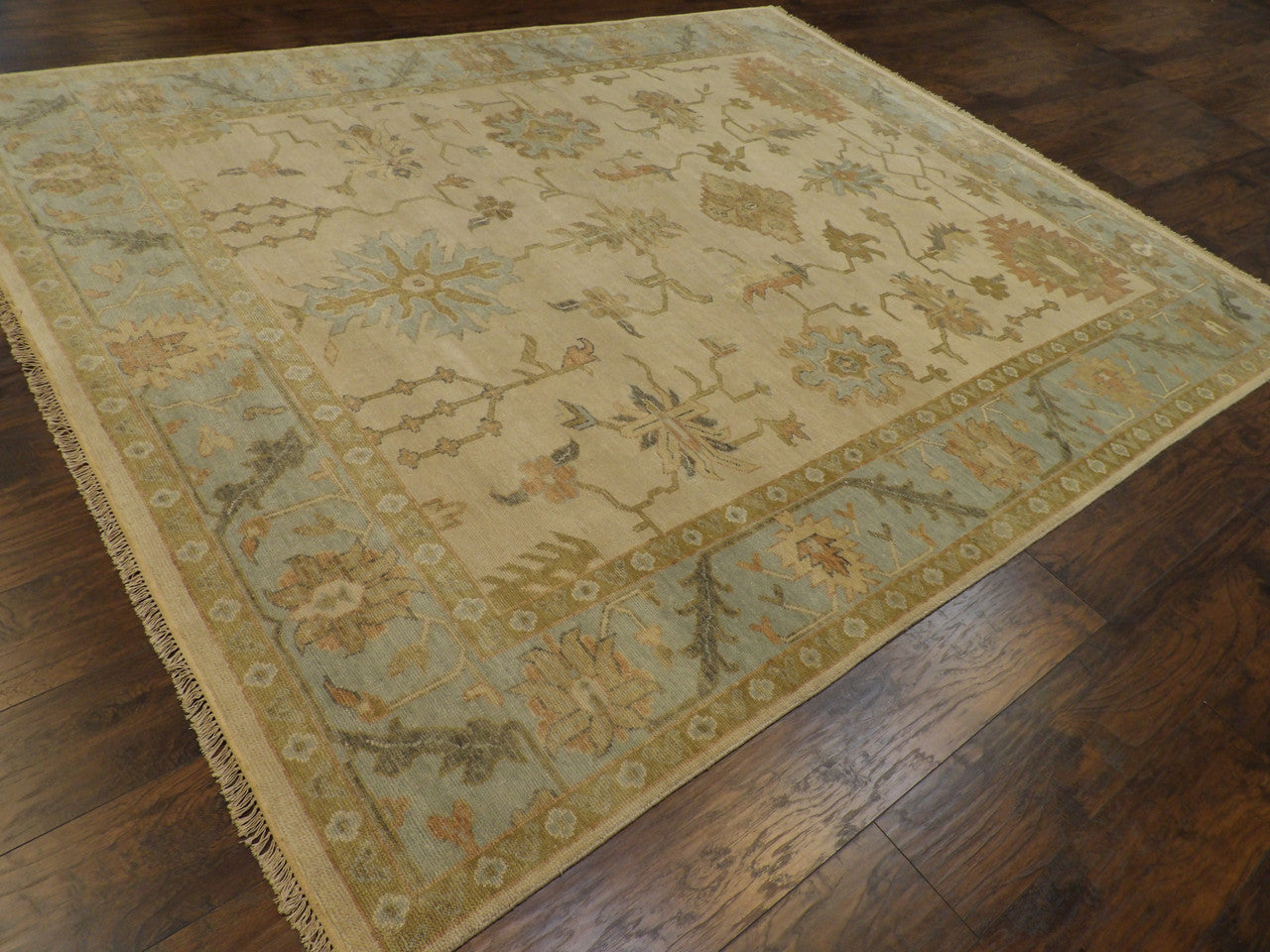 Beige and blue Anatolian Oushak rug in a living room setting