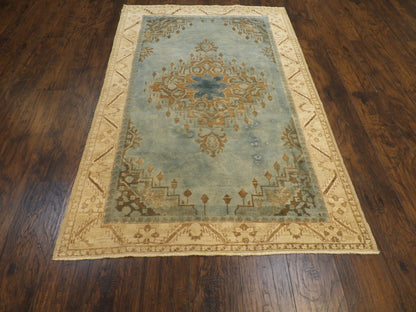 Close-up of wool pile, beige and teal rug