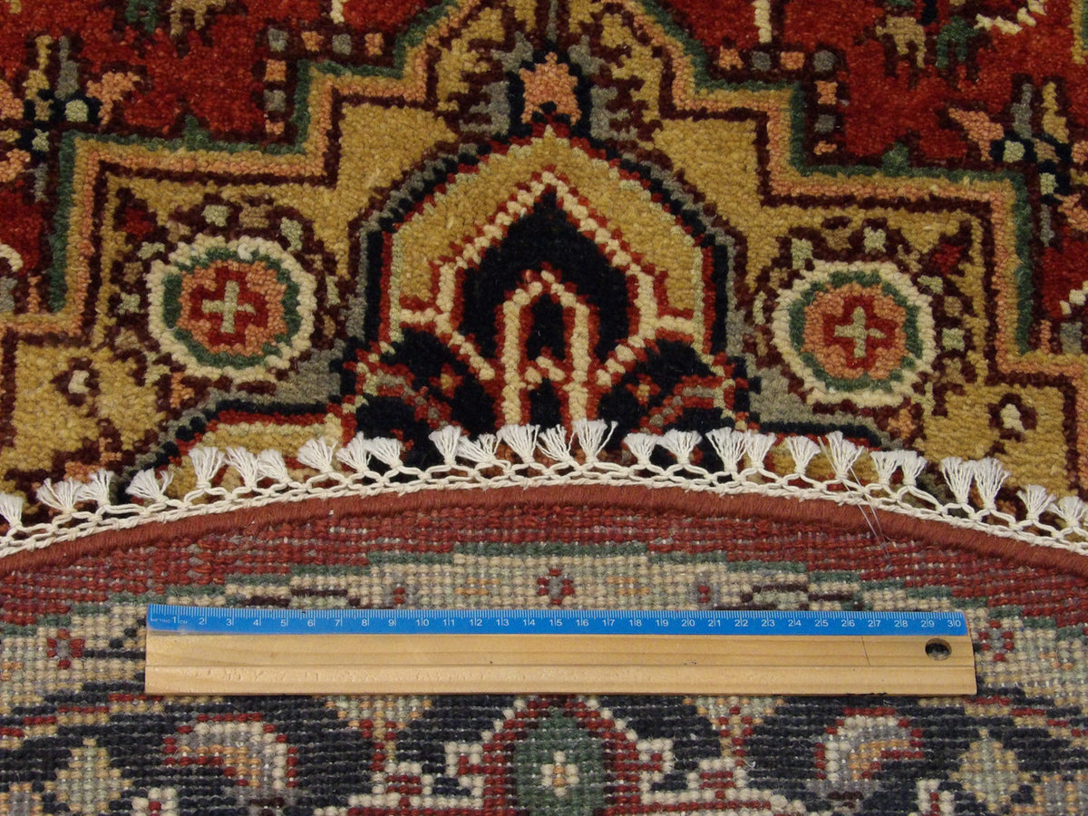 Blue and red Heriz round rug in room setting