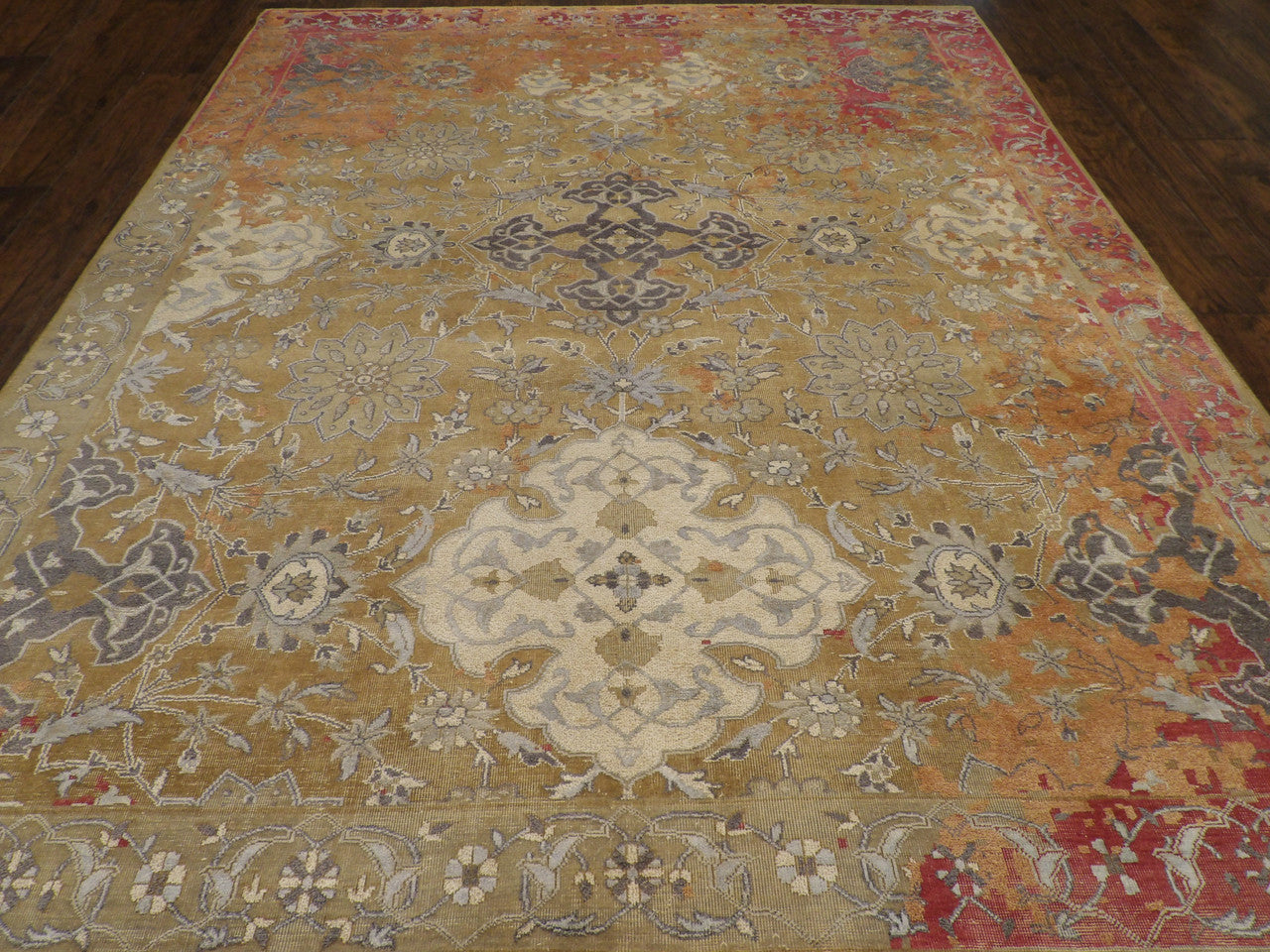 Close-up of low pile wool texture, gold and red rug