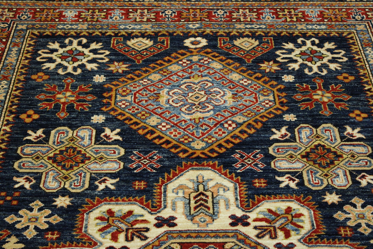 Blue & Red Tribal Super Fine Kazak rug in room setting