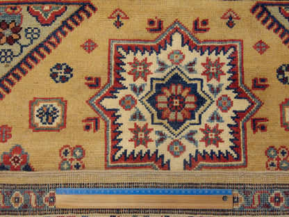 Gold & Beige Tribal Kazak rug in room setting
