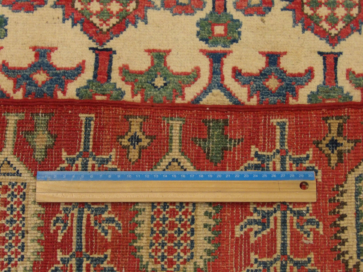 Beige & Red Tribal Super Kazak rug in room setting