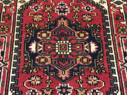 Tribal Heriz wool texture close-up, red