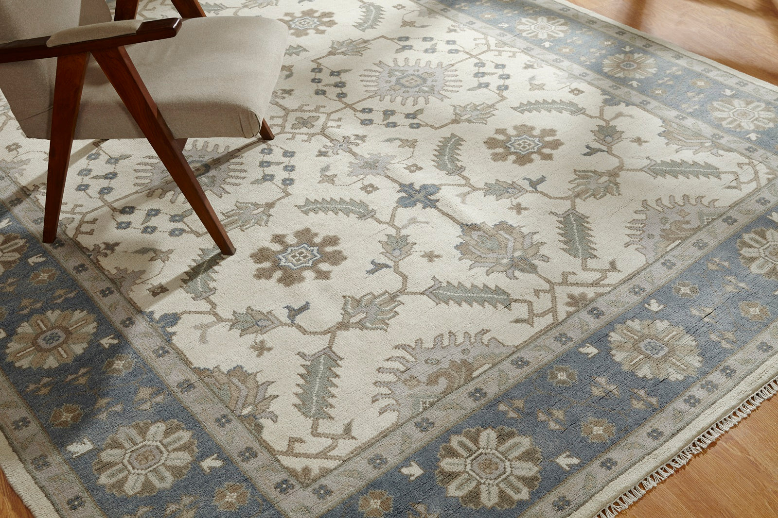 Beige and blue Tabriz rug in room setting