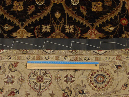 Black and gold Mashad rug in room setting