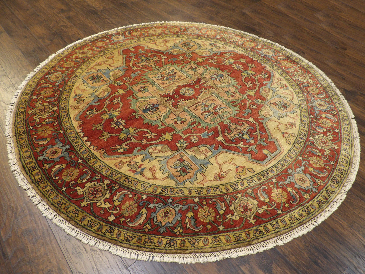 Gold and rust round Sherapi rug in a living room setting