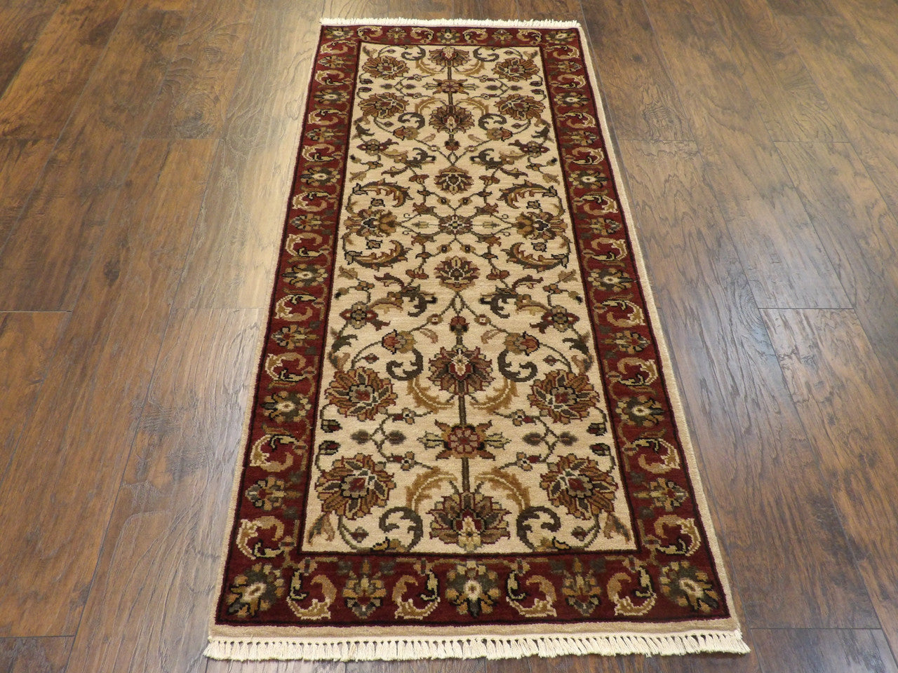 Beige and red Kashan runner in hallway setting