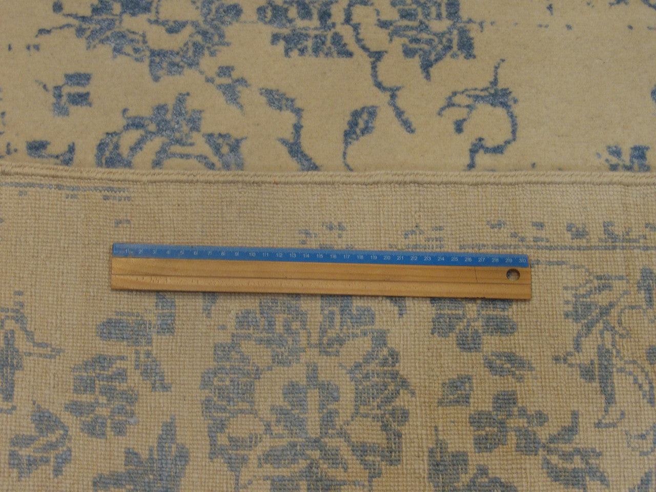 Blue and ivory transitional rug in room setting